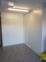 Corner garage storage with white vinyl sliding doors