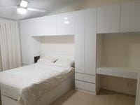 Surrounding bed storage with desk & overhead cupboards