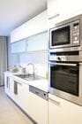 White Kitchen with stainless steel appliances.