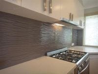 Textured Glass adds a unique finish to the kitchen. The pattern is to the wall and leaves a smooth undulating surface to clean. Terranora