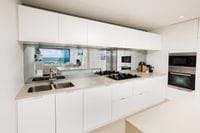 Mirrored Glass Splashback, Kirra Gold Coast. Mirror adds space and sophistication to the kitchen